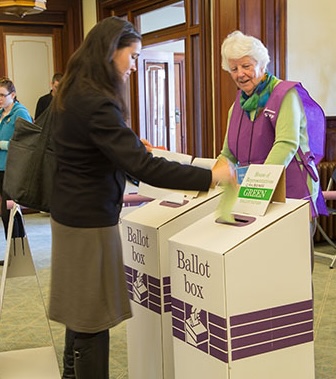 A woman placing her paper ballot for the House of Representatives, 2016 Australian federal election, in the ballot box.